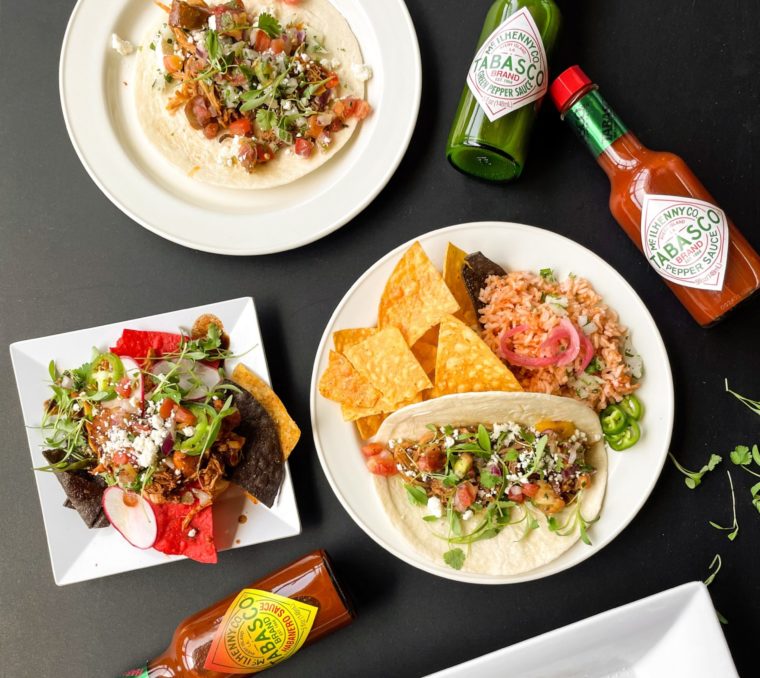 tex-mex cuisine spread with bottles of tabasco hot sauce